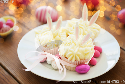 Image of cupcakes with easter eggs and candies on table