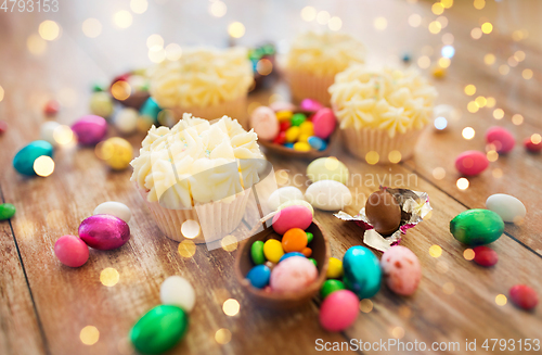 Image of cupcakes with chocolate eggs and candies on table