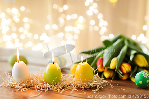 Image of candles in shape of easter eggs and tulip flowers