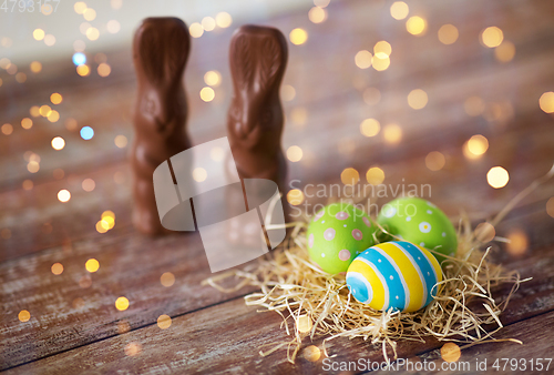 Image of easter eggs in straw nest and chocolate bunnies