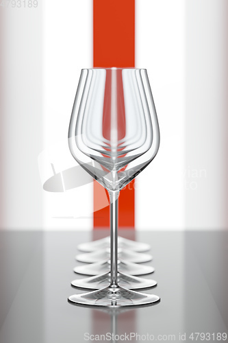 Image of wineglasses in a row with a red stripe