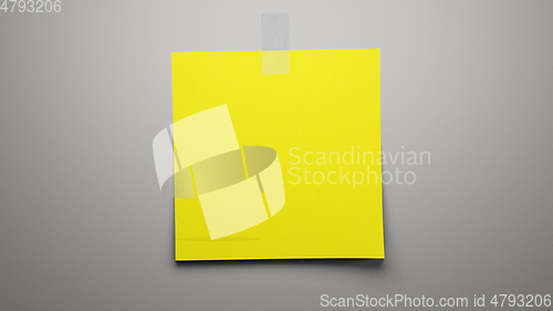 Image of yellow paper on grey background