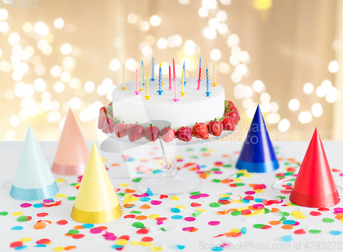 Image of birthday cake with candles and strawberries