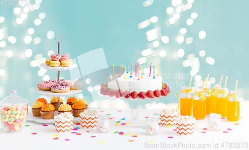 Image of food and drinks on table at birthday party