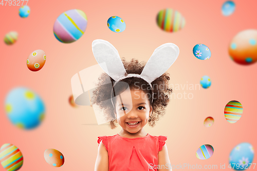 Image of happy little girl wearing easter bunny ears