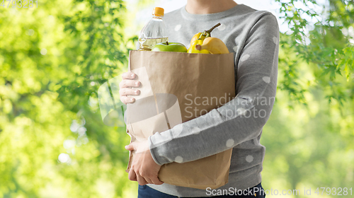 Image of close up of woman with paper bag full of food