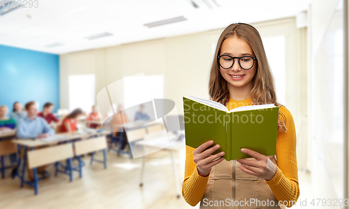 Image of teenage student girl in glasses reading book