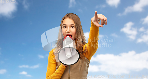 Image of teenage girl speaking to megaphone over sky