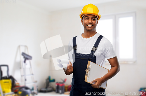 Image of happy indian builder with blueprint and clipboard