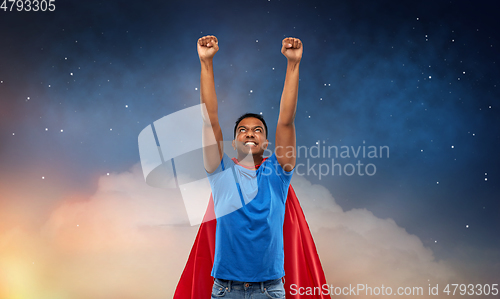 Image of indian man in superhero cape flying in night sky
