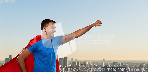 Image of indian man in superhero cape makes winning gesture