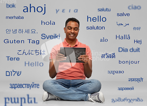 Image of happy indian man with tablet pc