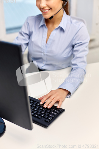 Image of businesswoman with headset and computer at office