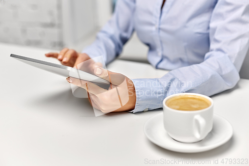 Image of businesswoman with tablet pc and coffee at office