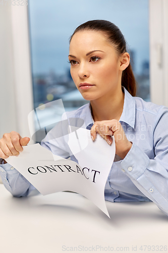 Image of businesswoman terminating contract at office