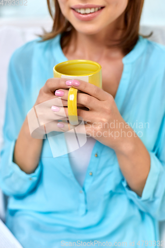 Image of close up of happy woman with cup of tea or coffee