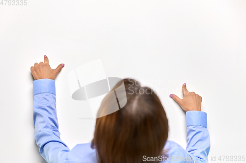 Image of businesswoman touching white table with fingers