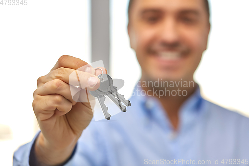 Image of close up of smiling man holding house keys