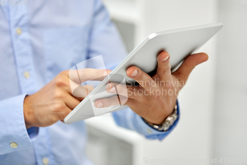 Image of close up of male hands with tablet pc computer