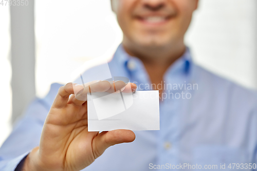 Image of close up of smiling man holding business card