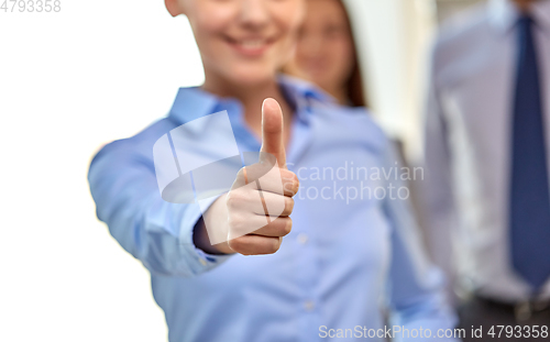 Image of close up of happy businesswoman showing thumbs up