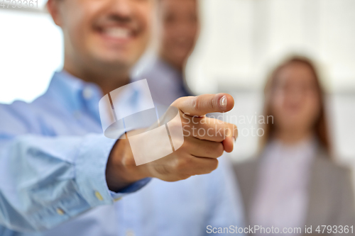 Image of close up of smiling businessman pointing finger