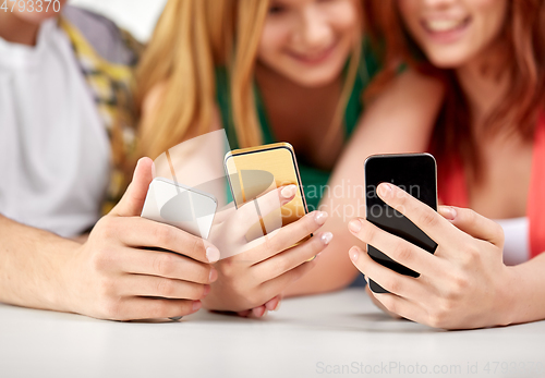 Image of close up of hands with smartphones