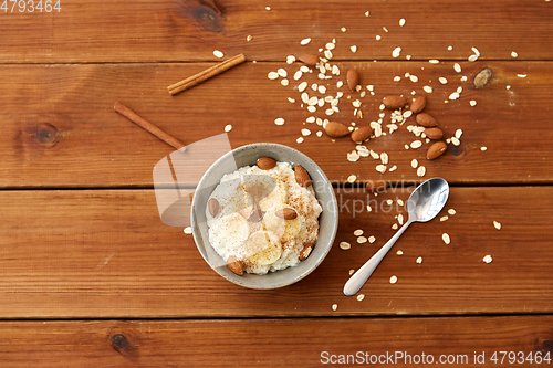 Image of oatmeal with banana and almond on wooden table