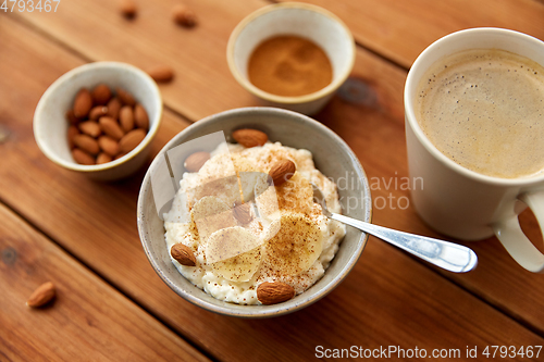 Image of oatmeal with banana and almond on wooden table