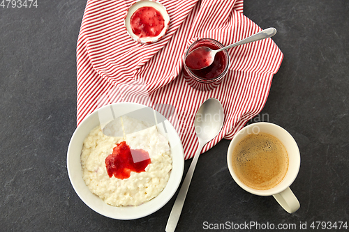 Image of porridge breakfast with jam, spoon and coffee