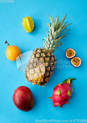 Image of pineapple with other fruits on blue background