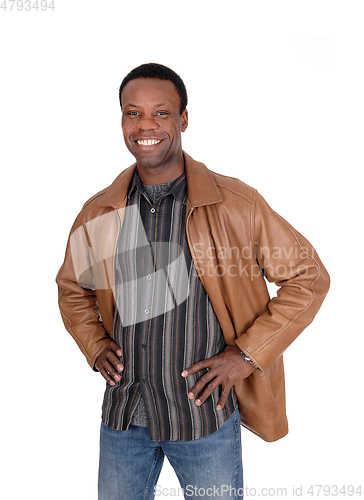 Image of Smiling African man standing in leather jacket