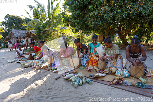 Image of Malagasy woman from village selling souvenir, Madagascar