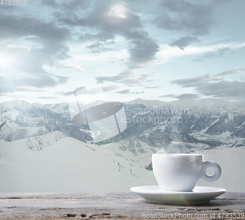 Image of Single tea or coffee cup and landscape of mountains on background