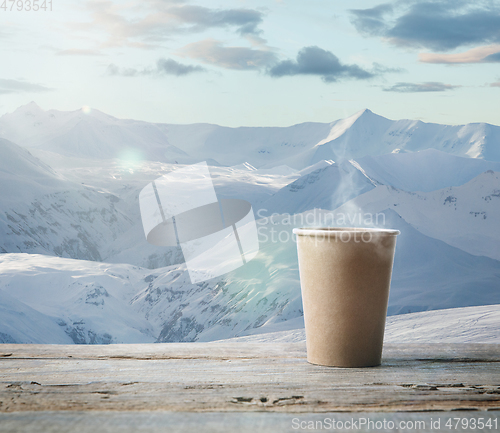 Image of Single tea or coffee mug and landscape of mountains on background