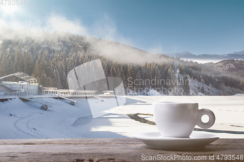 Image of Single tea or coffee cup and landscape of mountains on background