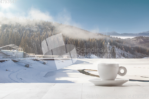 Image of Single tea or coffee cup and landscape of mountains on background