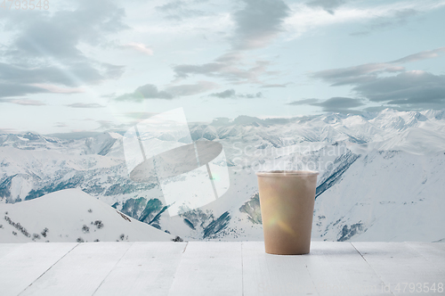 Image of Single tea or coffee mug and landscape of mountains on background