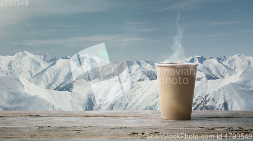 Image of Single tea or coffee mug and landscape of mountains on background