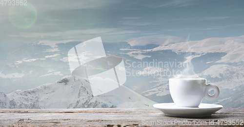 Image of Single tea or coffee cup and landscape of mountains on background