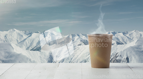 Image of Single tea or coffee mug and landscape of mountains on background