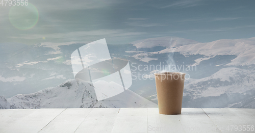 Image of Single tea or coffee mug and landscape of mountains on background