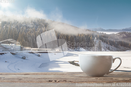 Image of Single tea or coffee cup and landscape of mountains on background