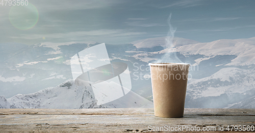 Image of Single tea or coffee mug and landscape of mountains on background