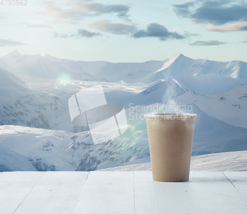 Image of Single tea or coffee mug and landscape of mountains on background