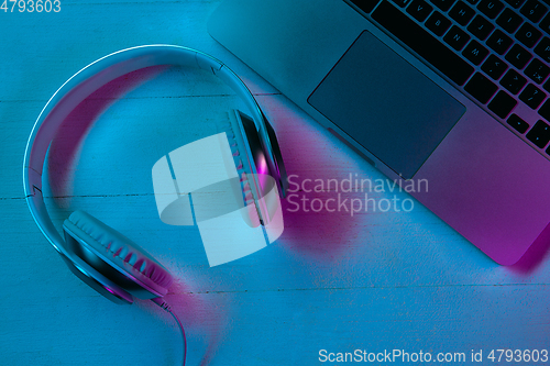 Image of Top view of set of gadgets in purple neon light