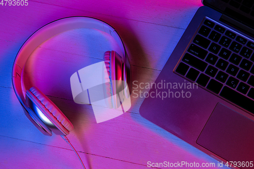 Image of Top view of set of gadgets in purple neon light