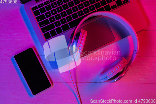 Image of Top view of set of gadgets in purple neon light