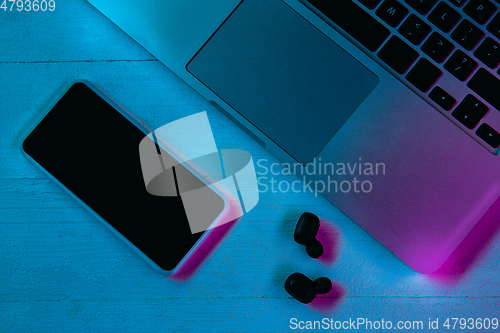 Image of Top view of set of gadgets in purple neon light