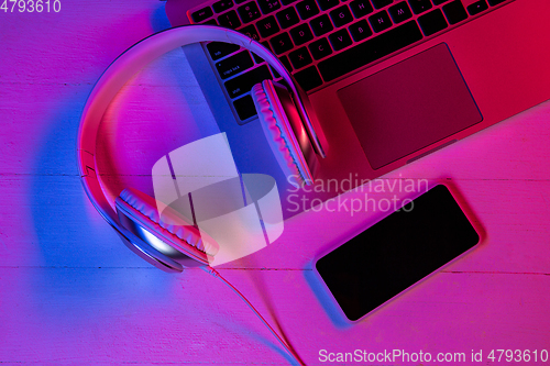 Image of Top view of set of gadgets in purple neon light